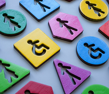 Wheelchair cut outs in wood pieces. Inclusion and diversity